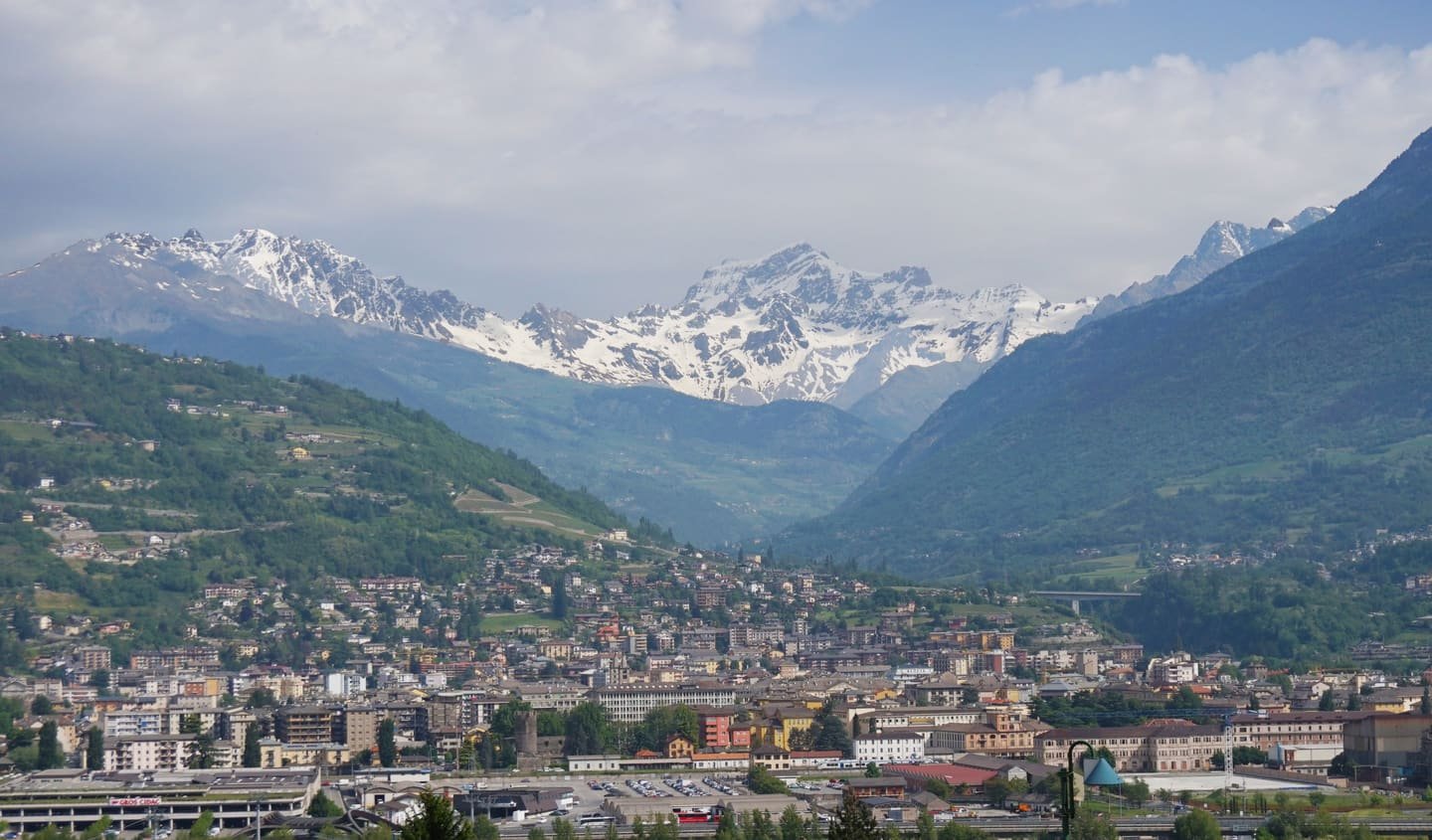 The city of Aosta on the valley floor beneath snow-covered peaks