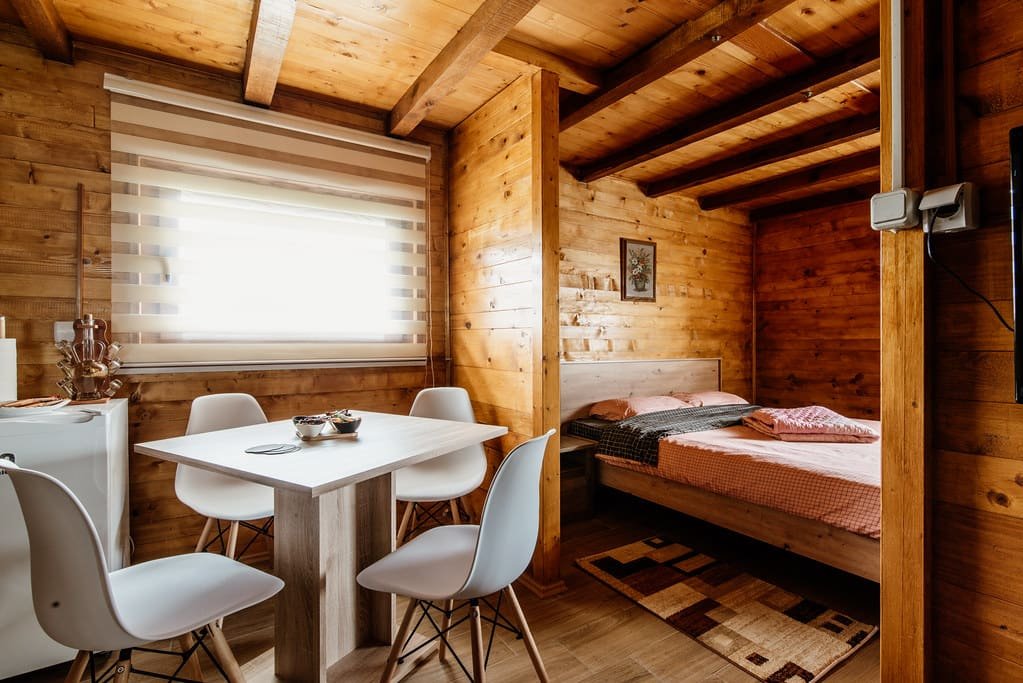 A simple modern room lined in pale timber