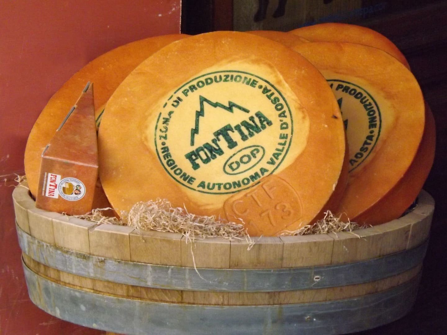 Wheels of Fontina DOP stamped with the consortium mark