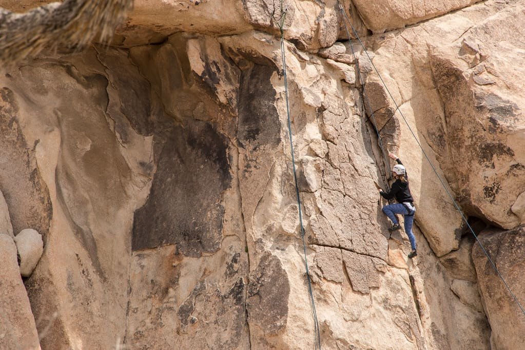 A climber moving up a steep rock face