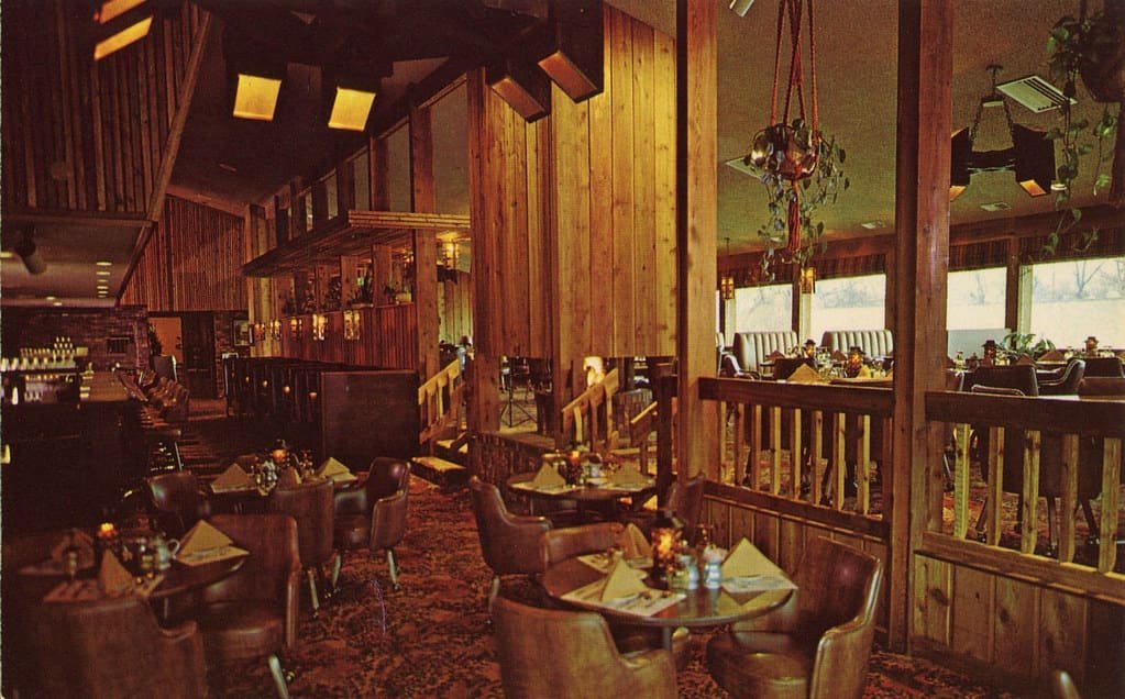 A wood-panelled alpine dining room laid for service