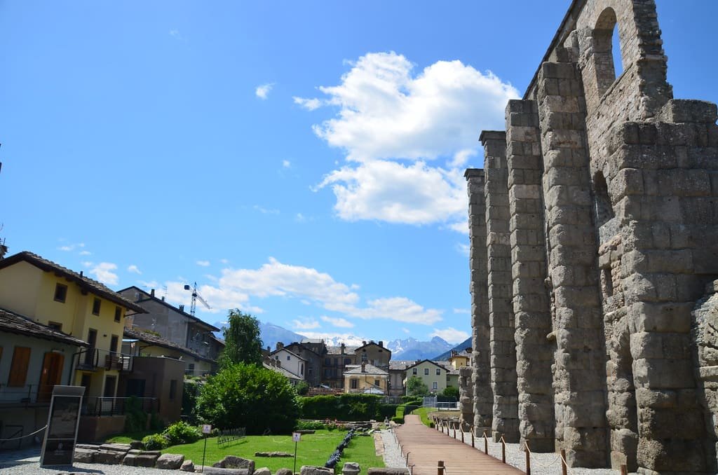 The tall arched façade of the Roman theatre in Aosta